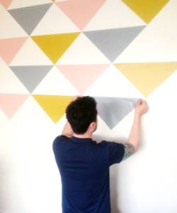 Skilled technicians installing wallpaper with precision