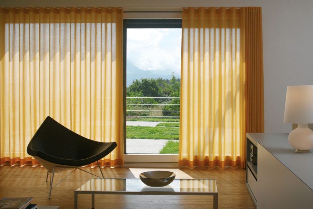 Energy-efficient motorized curtains in a bright dining room
