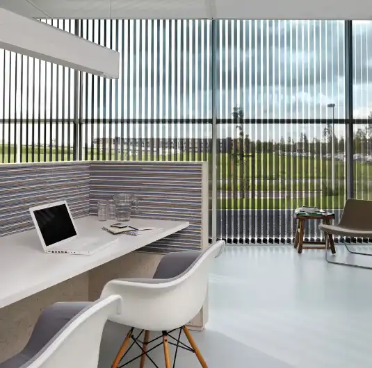 Office window with horizontal wooden blinds and a city view