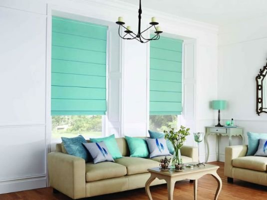 Elegant Roman blinds with a blackout feature in a home theater
