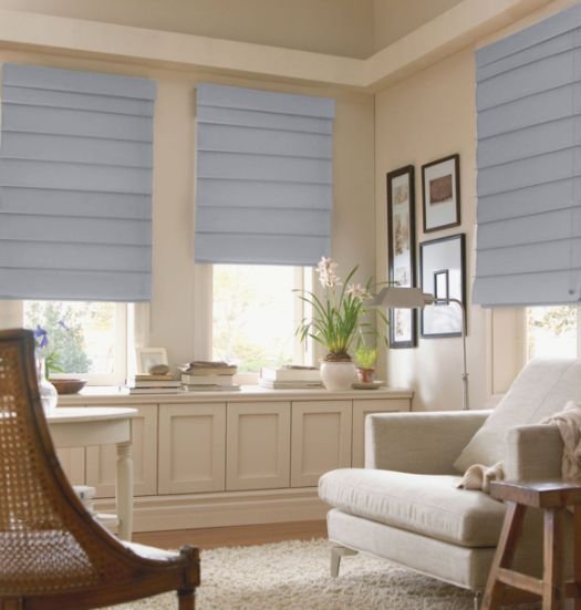 Custom-made Roman blinds in a stylish bedroom setting