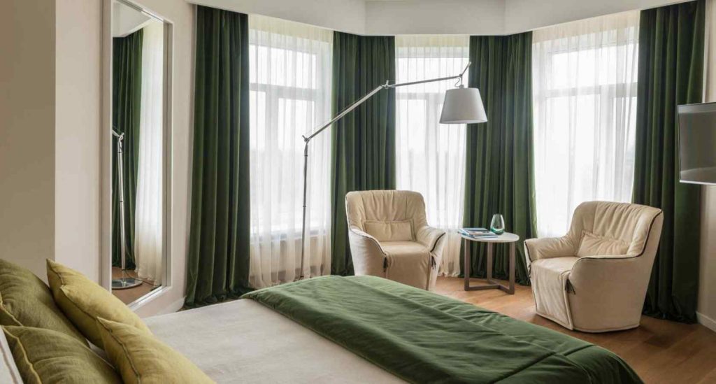 Luxurious hotel room with velvet & sheer curtains