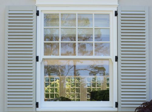 Elegant white window shutters installed in a modern living room