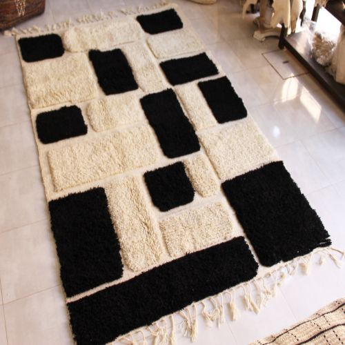 Monochrome geometric rug with fringed edges