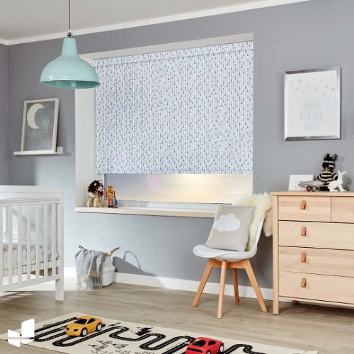 Patterned white roller blind in a nursery