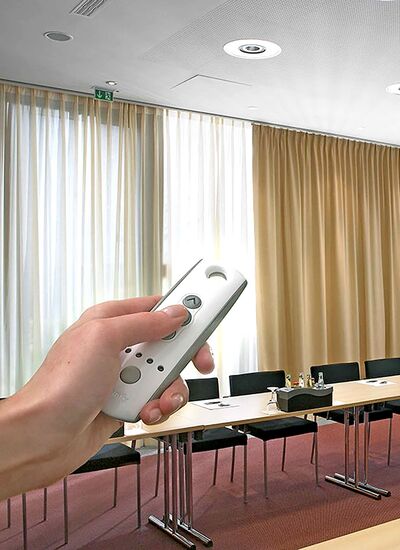 Person With Remote in Hand Operating Curtains